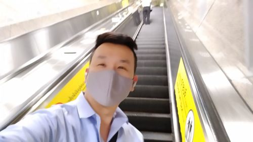 Portrait of young man in train