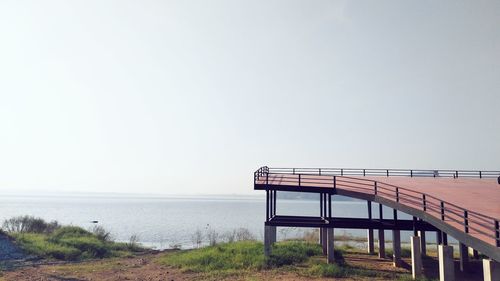 Lifeguard hut on beach against clear sky