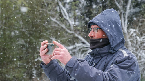 Rear view of man using mobile phone