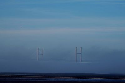 Severn bridge over seascape against blue sky