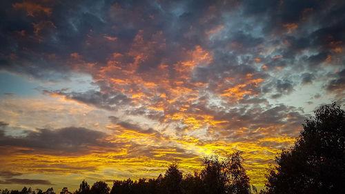 Low angle view of dramatic sky during sunset