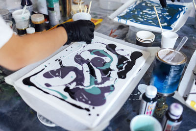 Cropped hand of scientist working on table