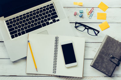 Close-up of office supplies and laptop on table