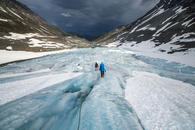 Tourists on snow covered landscape