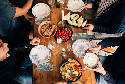 High angle view of young men having lunch together