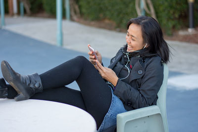 Young woman sitting outdoors