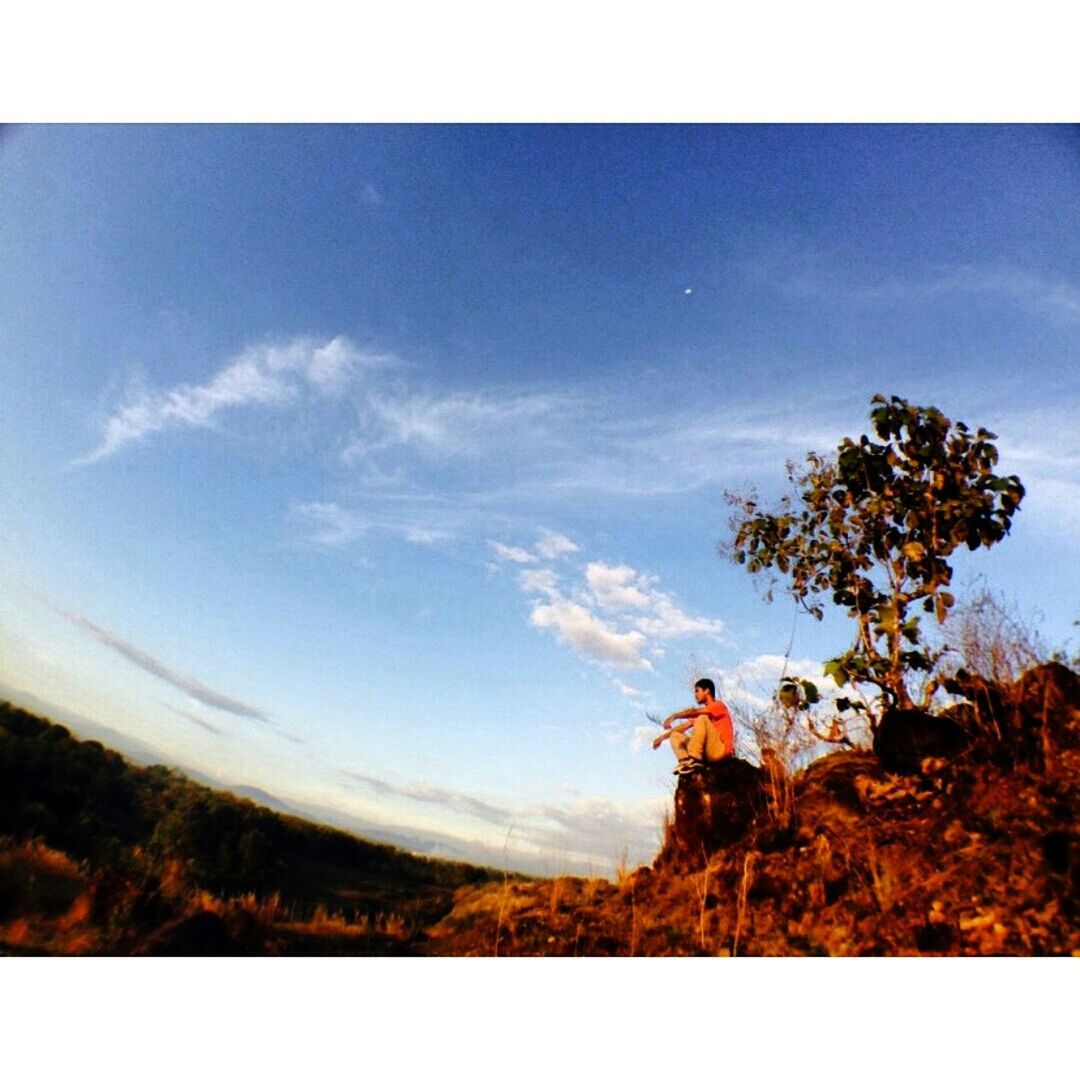 transfer print, sky, auto post production filter, tree, tranquility, tranquil scene, scenics, cloud - sky, nature, beauty in nature, landscape, men, cloud, blue, lifestyles, leisure activity, mountain, rock - object