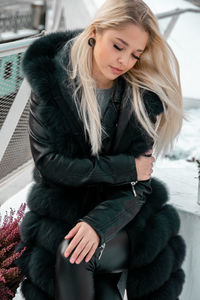 Portrait of beautiful woman with hand in winter