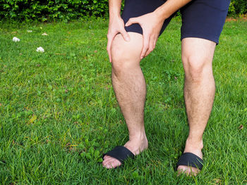 Low section of man legs on field