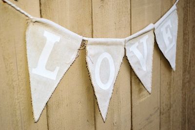 Close-up of flags hanging against the wall