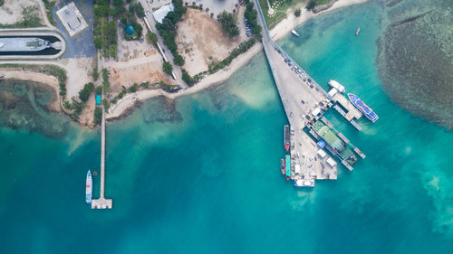 Aerial view of ship moored at harbor by city