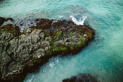 High angle view of rocks on sea