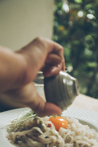 Cropped hand of person preparing food