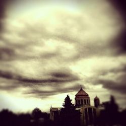 Low angle view of building against cloudy sky