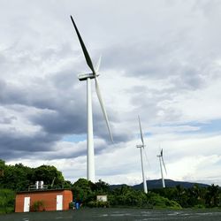 Low angle view of wind turbine against sky