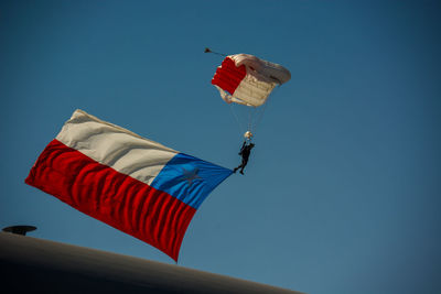 Low angle view of flag against blue sky