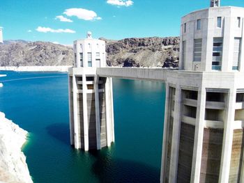 Hoover dam by mountains against sky