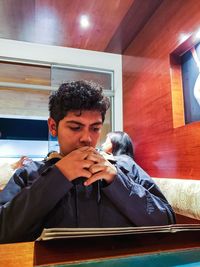 Man reading menu while sitting at table