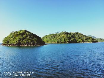 Scenic view of sea against clear blue sky