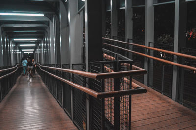 Rear view of man walking on staircase in building