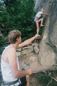 Young man climbing on rock