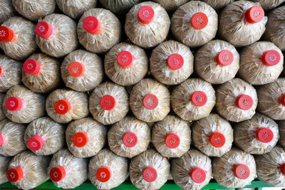 Stack of food in bottles at supermarket for sale