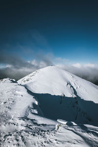 Scenic view of snowcapped mountain against sky