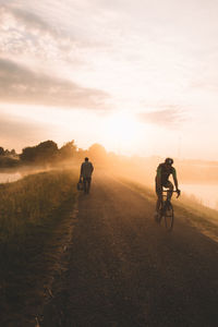 Man riding motorcycle on landscape against sky