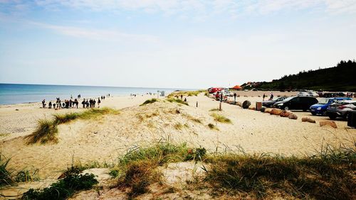 People on beach against sky