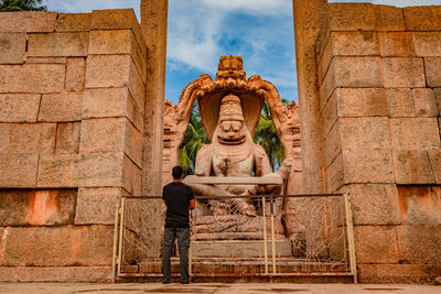 Statue of buddha against wall