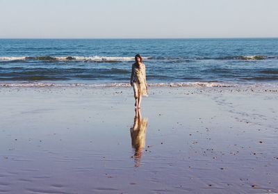 Full length of woman walking at beach