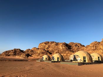 Scenic view of desert against clear blue sky