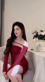 Portrait of young woman sitting on bed at home