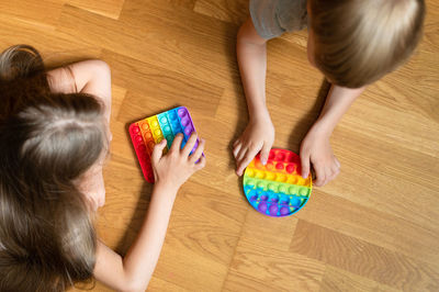 High angle view of girl playing with toy on floor