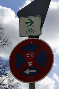 Low angle view of road sign against sky