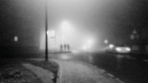 Defocused image of illuminated street at night