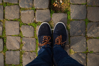 Low section of man standing on footpath