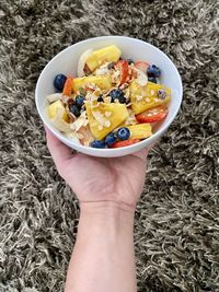 Midsection of person holding bowl