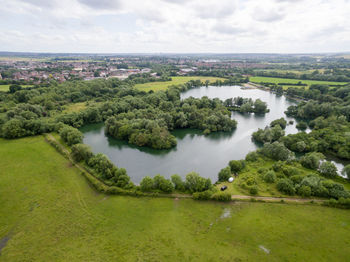 Scenic view of river amidst trees against sky