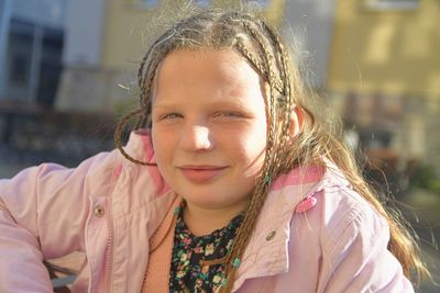 Portrait of little girl with afro-pigtails gathered in a tail.  pigtails with interwoven strands.