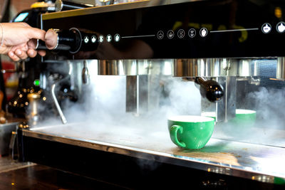 Man preparing coffee in cafe