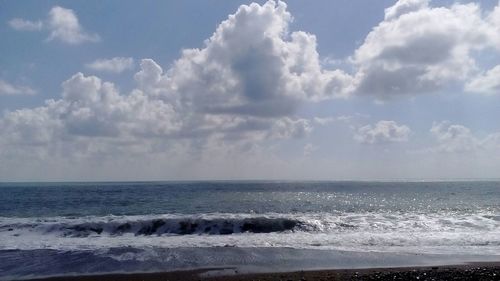 Scenic view of sea against cloudy sky
