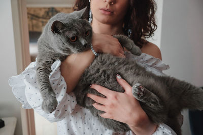 Midsection of woman with cat