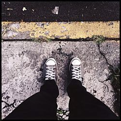 Low section of person standing on road