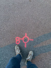 Low section of man standing on street