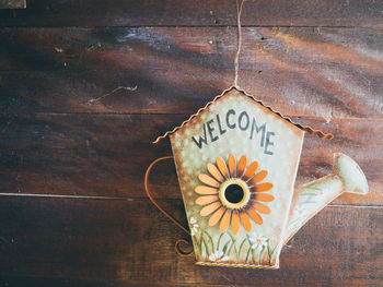 Close-up of clock hanging on table