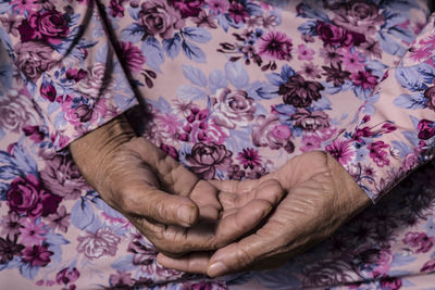 Midsection of person in floral pattern cloth