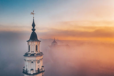 Tower of building against sky during sunset