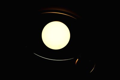 Close-up of illuminated lamp against black background