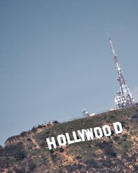 Low angle view of information sign against clear sky